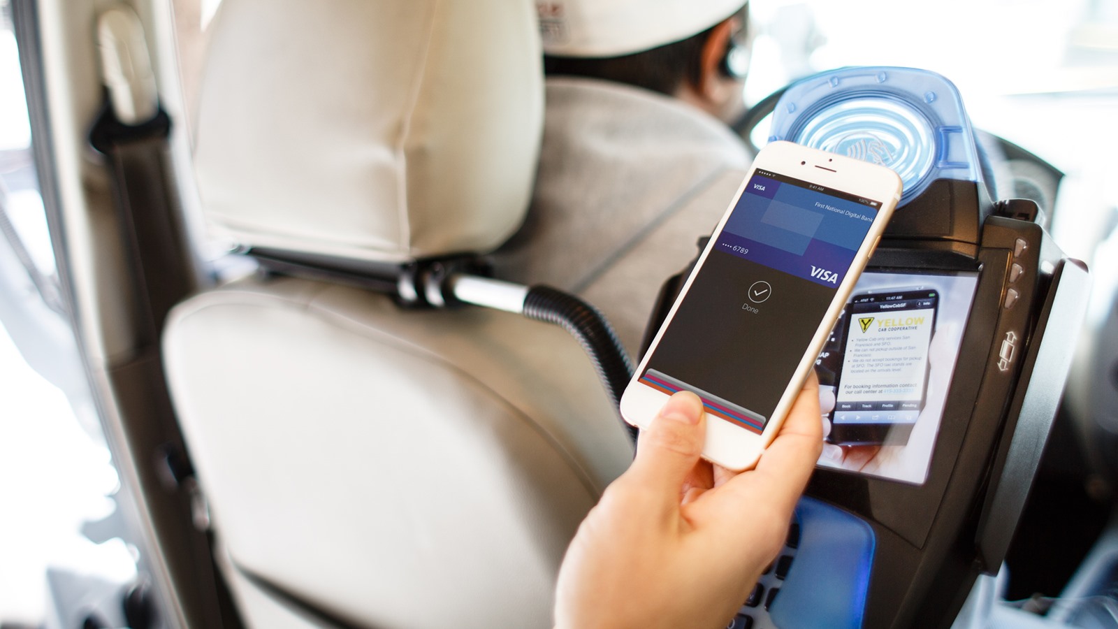person using mobile payment in taxi